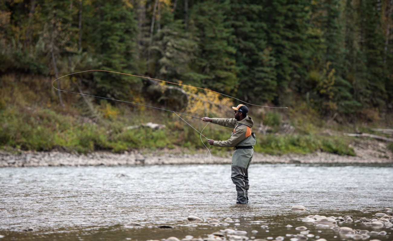 A person casting their line for fly fishing in the Peace River.