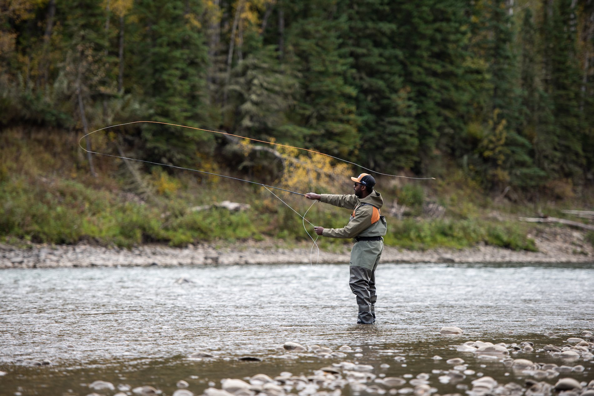 A person casting their line for fly fishing in the Peace River.
