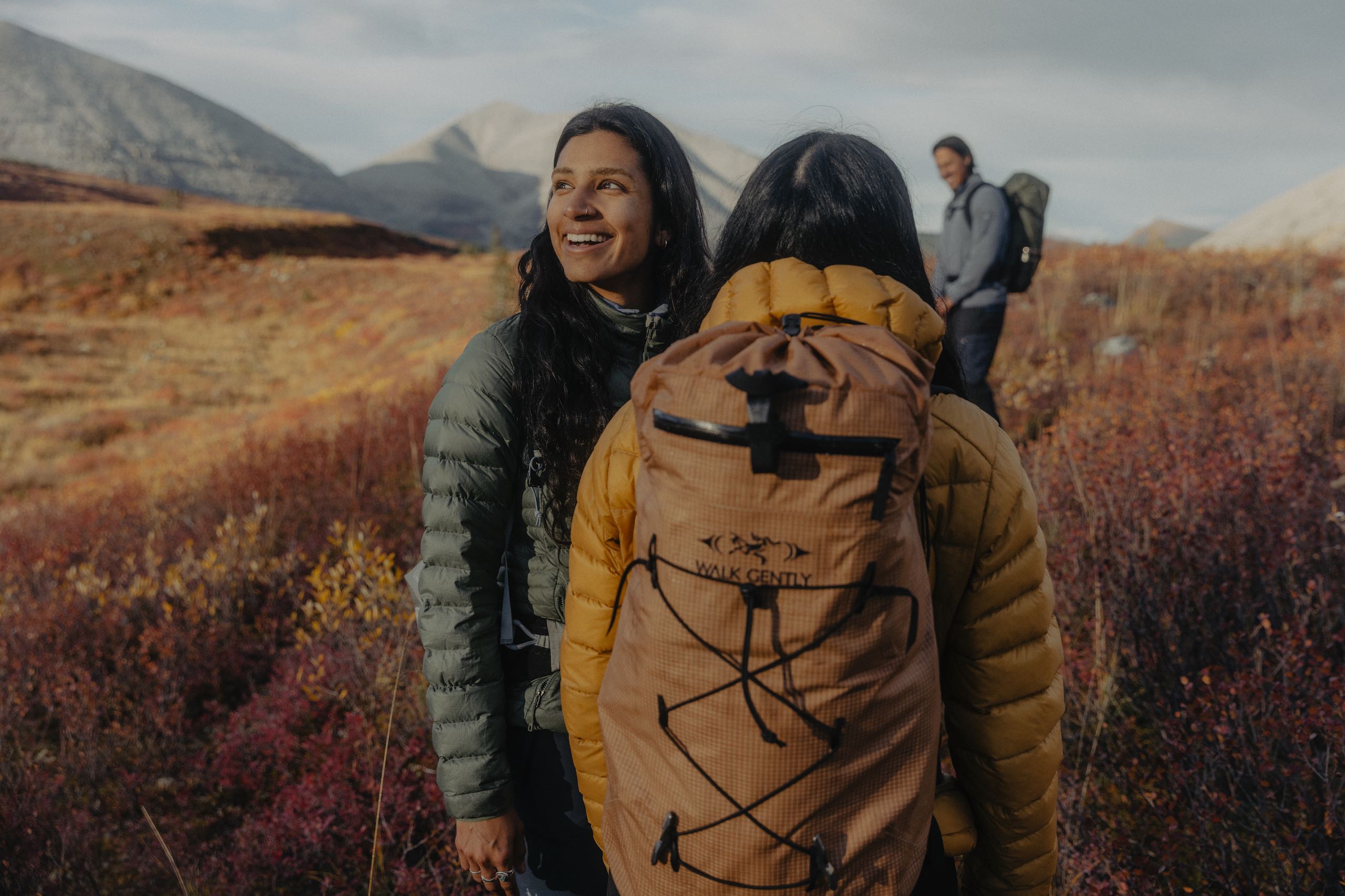 Three friends enjoying their hike along the Flowering Springs Trail in Stone Mountain Provincial Park in the Northern Rockies.