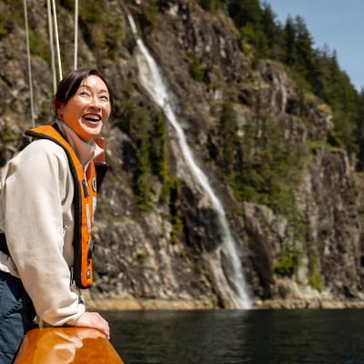 A guest enjoying the coastal scenery during a sailing tour with Maple Leaf Adventures.