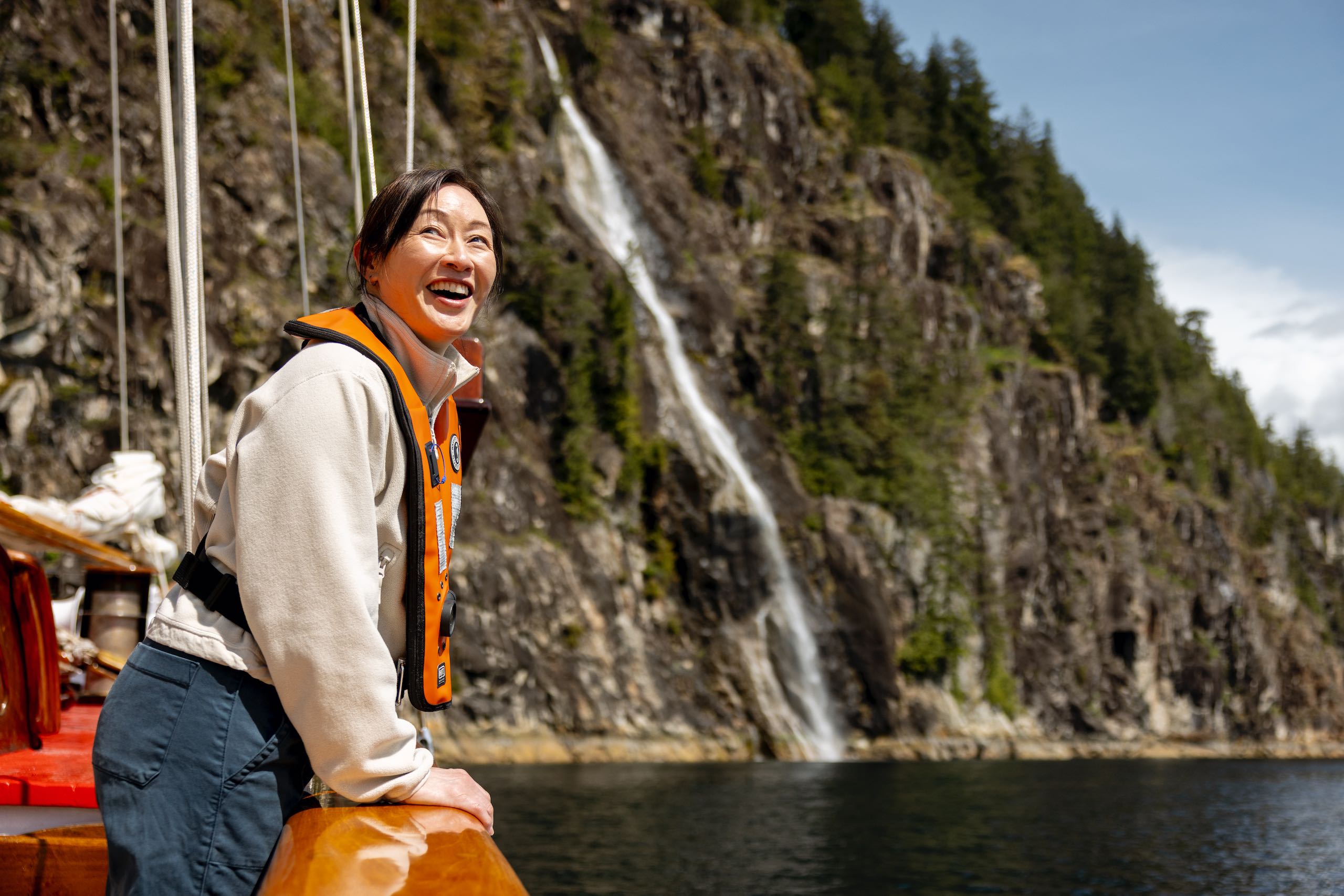 A guest enjoying the coastal scenery during a sailing tour with Maple Leaf Adventures.