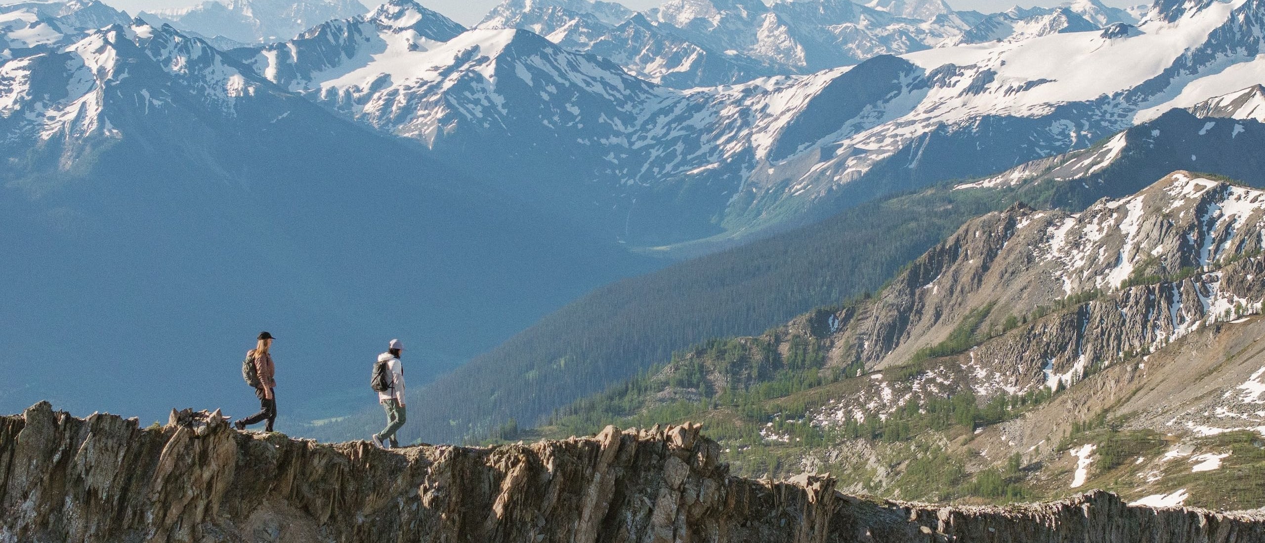 Two friends hiking alongside the glaciers and mountains of Bugaboo Provincial Park during a heli-hiking trip with CMH Bugaboos.