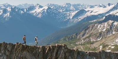 Two friends hiking alongside the glaciers and mountains of Bugaboo Provincial Park during a heli-hiking trip with CMH Bugaboos.