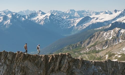 Two friends hiking alongside the glaciers and mountains of Bugaboo Provincial Park during a heli-hiking trip with CMH Bugaboos.