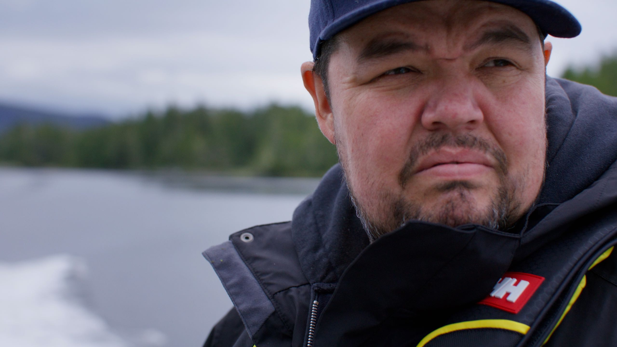 A still of William Housty on a boat, taken from the Illahee: Bears video.