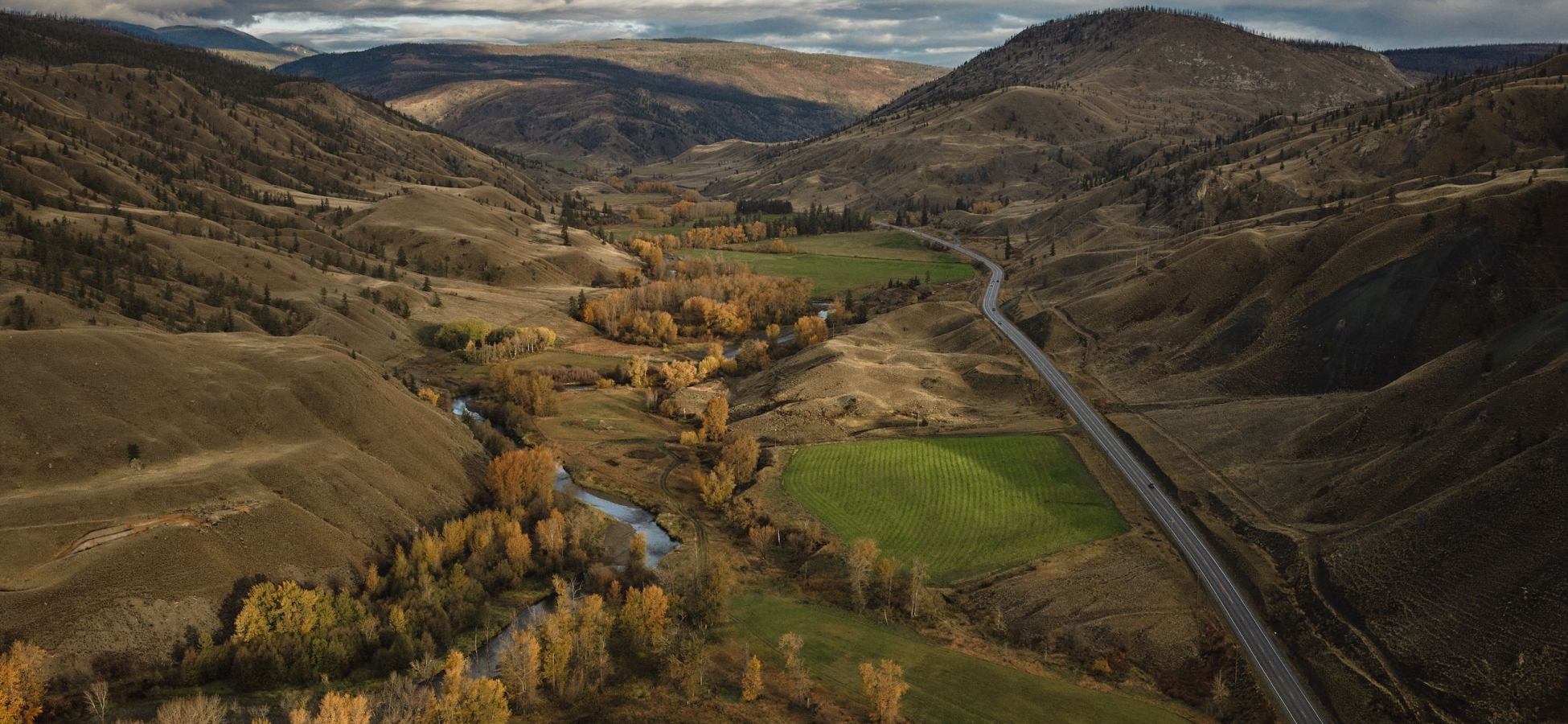 Aerial view of the Painted Hills, with autumn colors and the community of Cache Creek in the valley below.