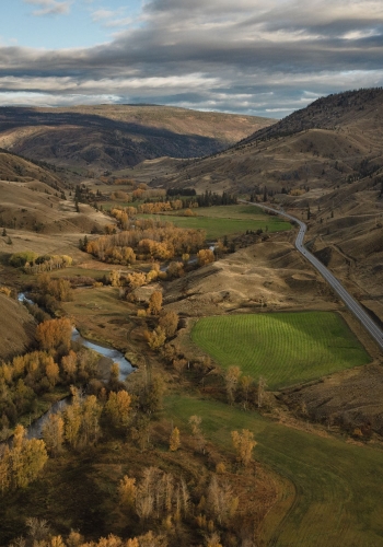 Aerial view of the Painted Hills, with autumn colors and the community of Cache Creek in the valley below.