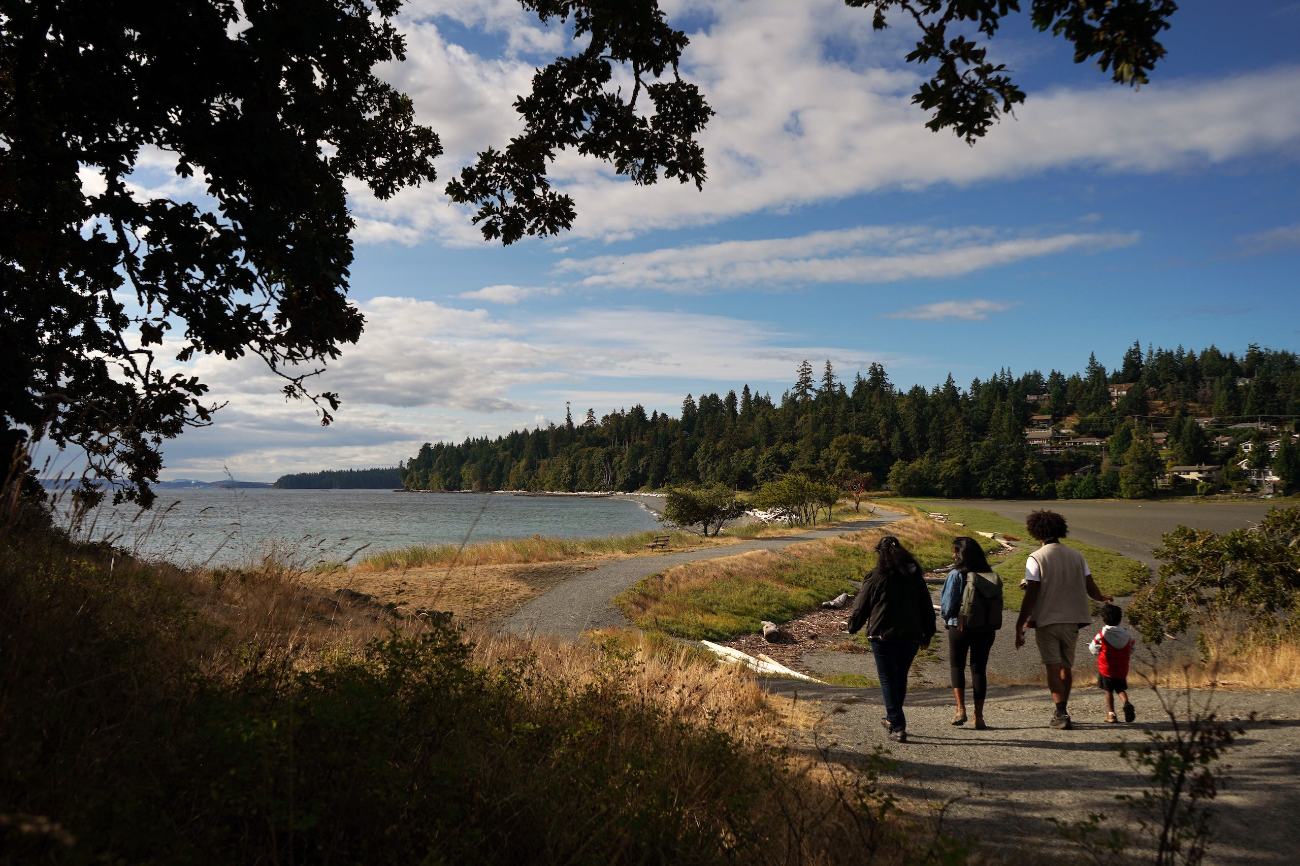 A family is exploring Pipers Lagoon Park on Vancouver Island. They are Bird Watching.