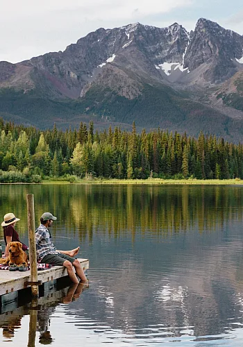 Leute, die auf einem Steg am Dennis Lake in Smithers sitzen