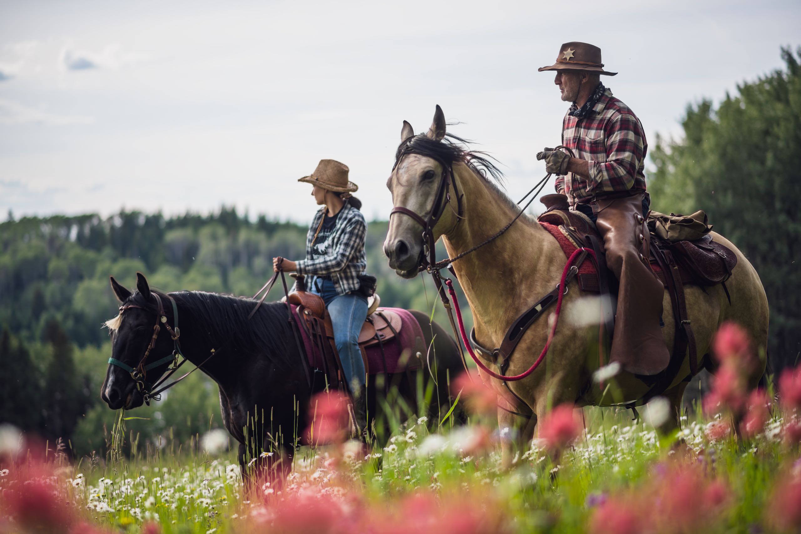 Trail rides through a field of wildflowers at Montana Hill Guest Ranch