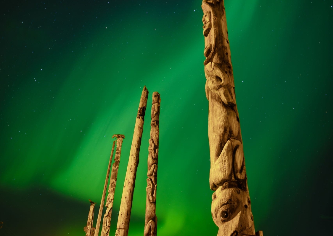 Gitwangak totem poles with Aurora Borealis