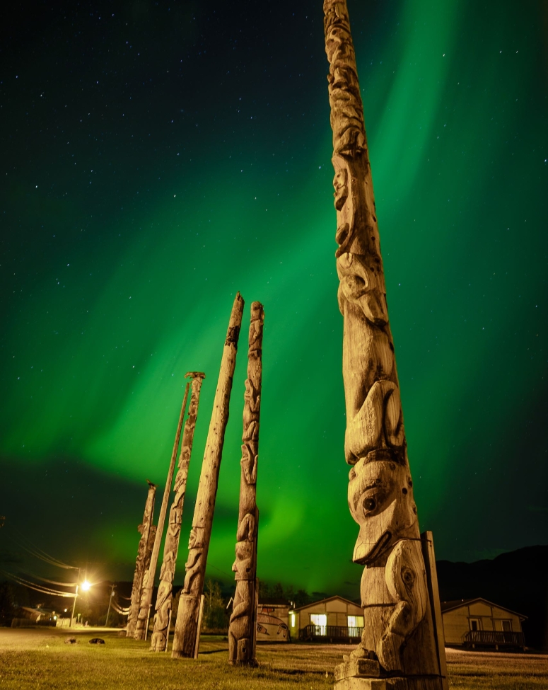 Gitwangak totem poles with Aurora Borealis