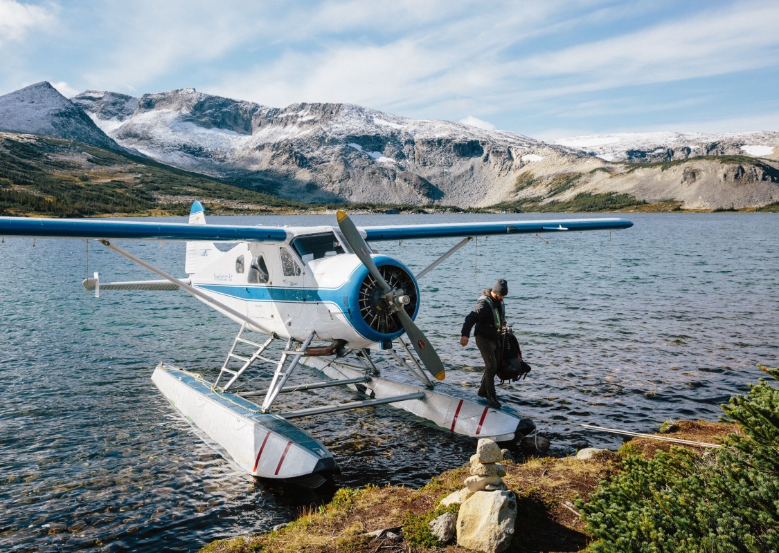 Person getting of a plane on Ptarmigan Lake