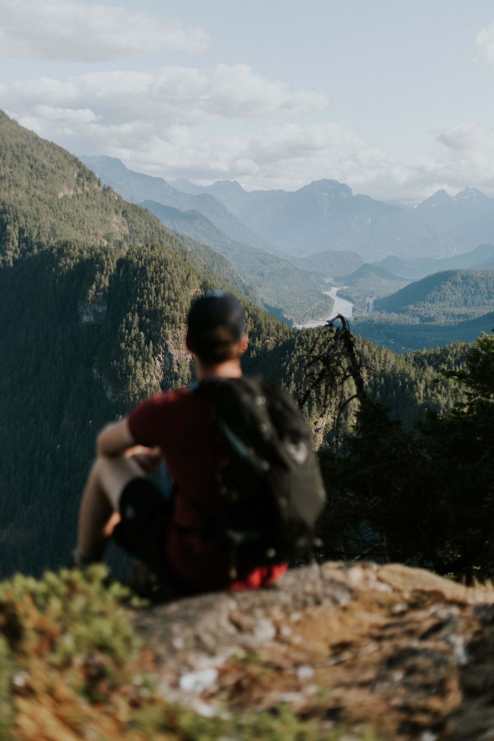 A man enjoying the view of the Fraser Canyon and surrounding mountains from the top of the Mount Lincoln Trail.