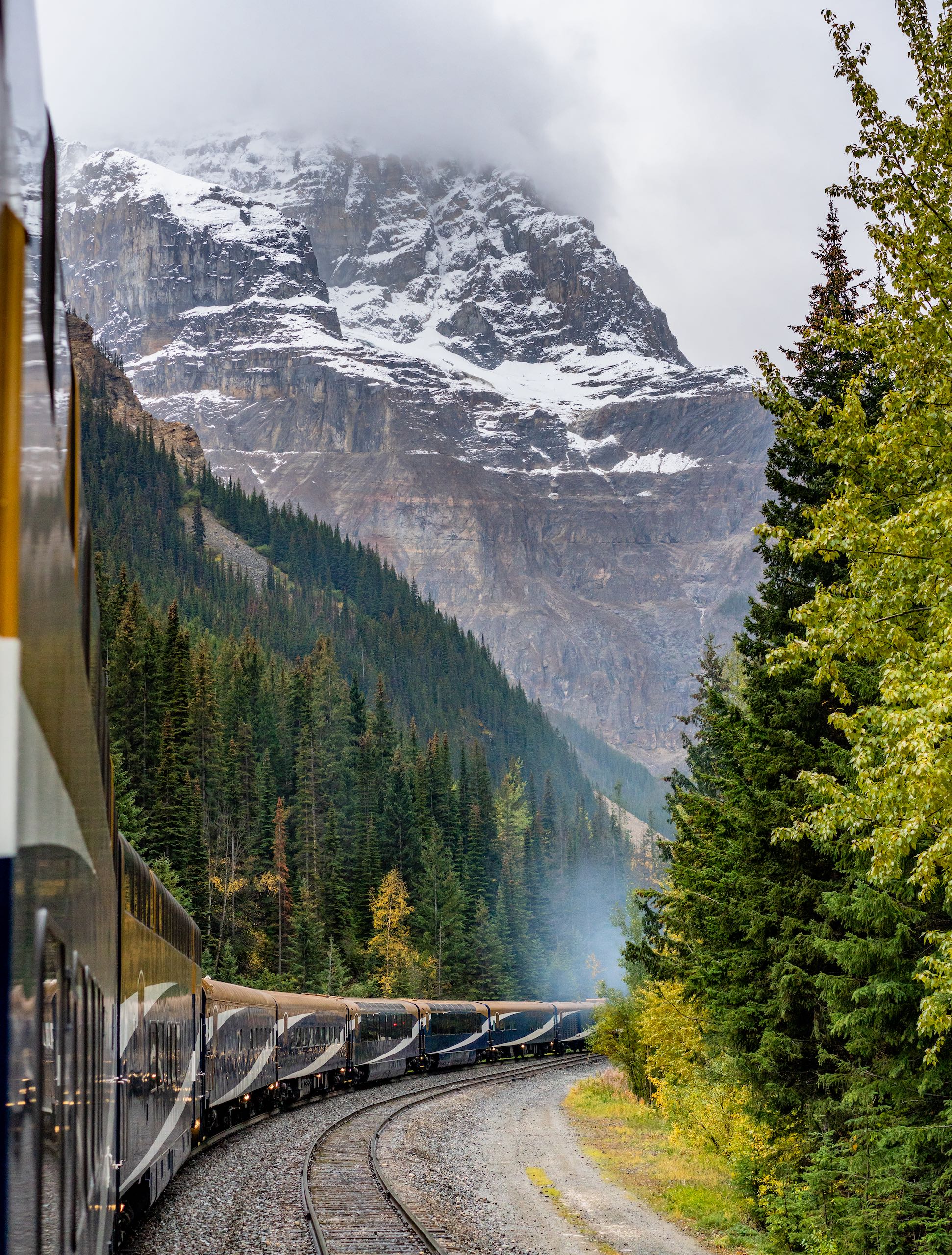 The Rocky Mountaineer train along side a mountain pass