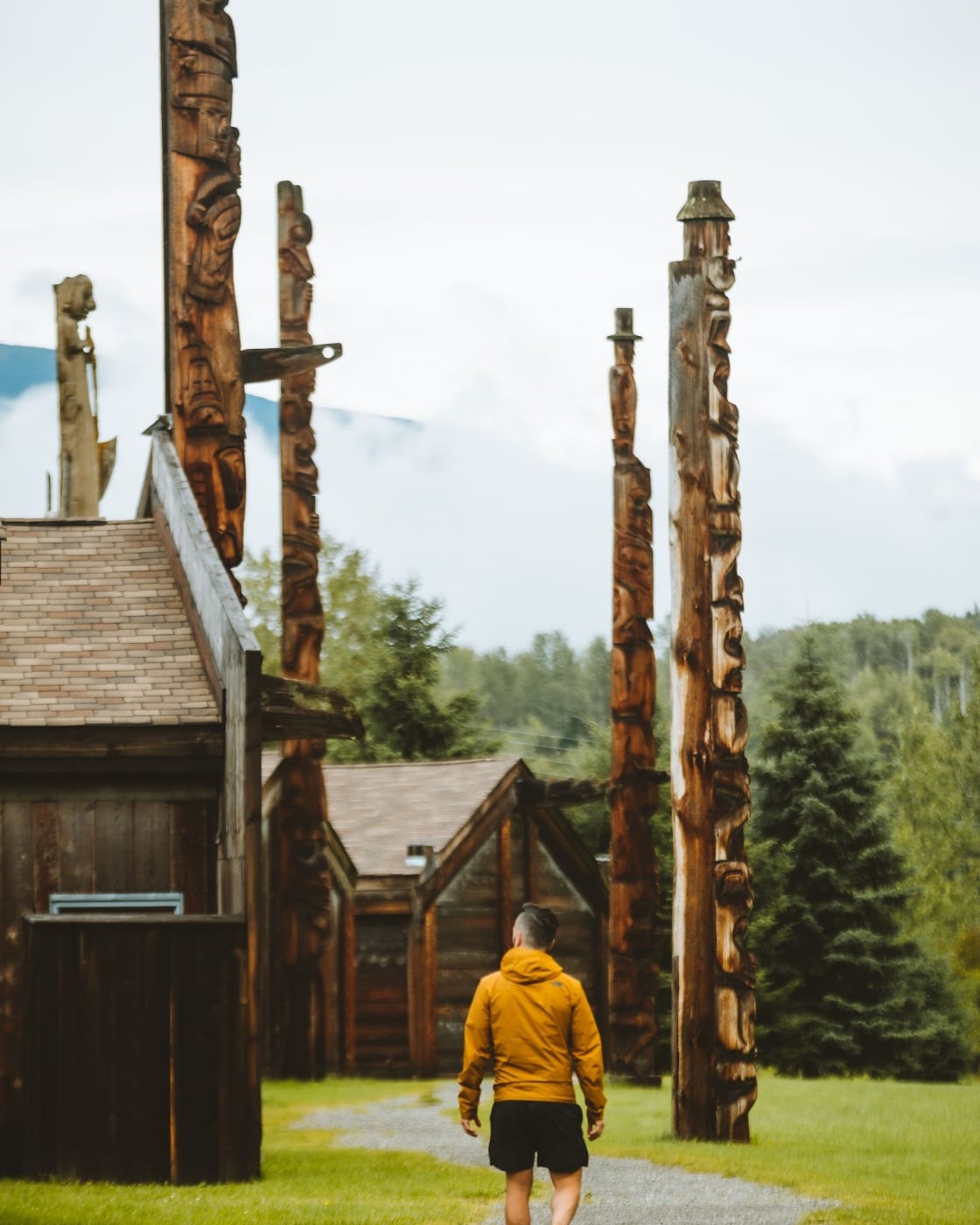 A man walking through 'Ksan Historical Village