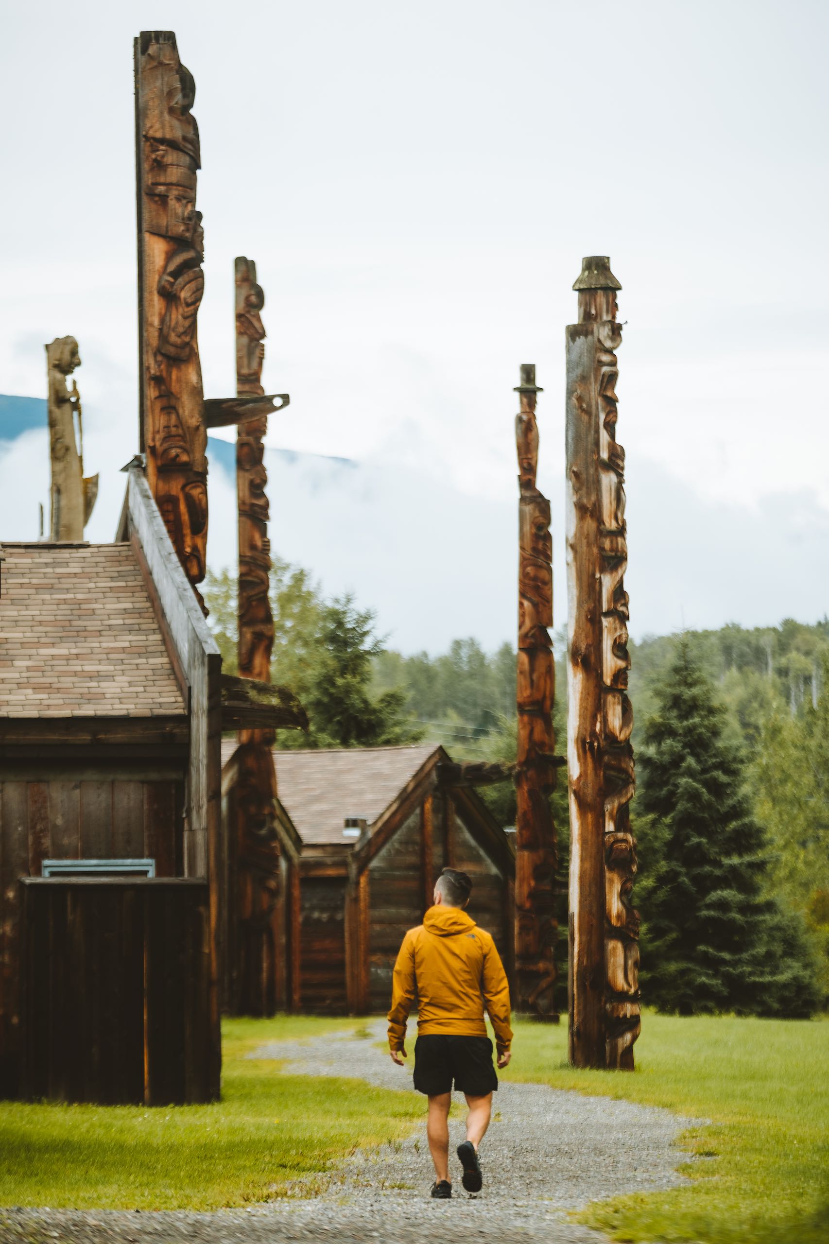 A man walking through 'Ksan Historical Village