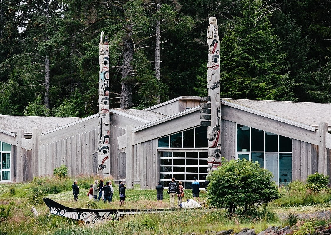 Haida Heritage Centre with people standing in the yard