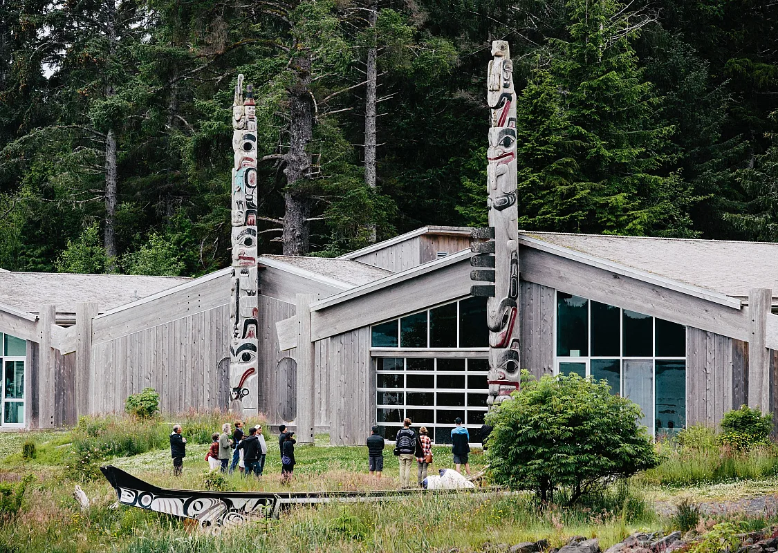 Haida Heritage Centre with people standing in the yard