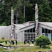 Haida Heritage Centre with people standing in the yard