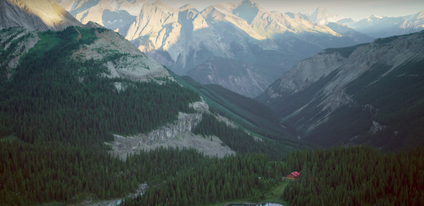 Mistaya Lodge in the distance surrounded by the Canadian Rockies