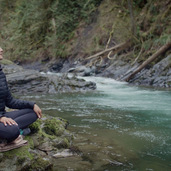 A woman standing next to a stream in BC