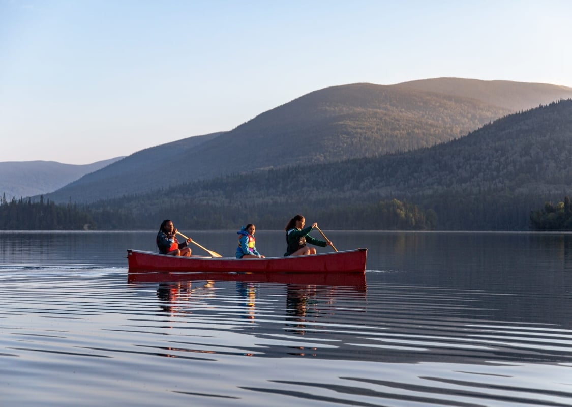 Family canoeing and kayaking on Morfee Lake in Mackenzie.