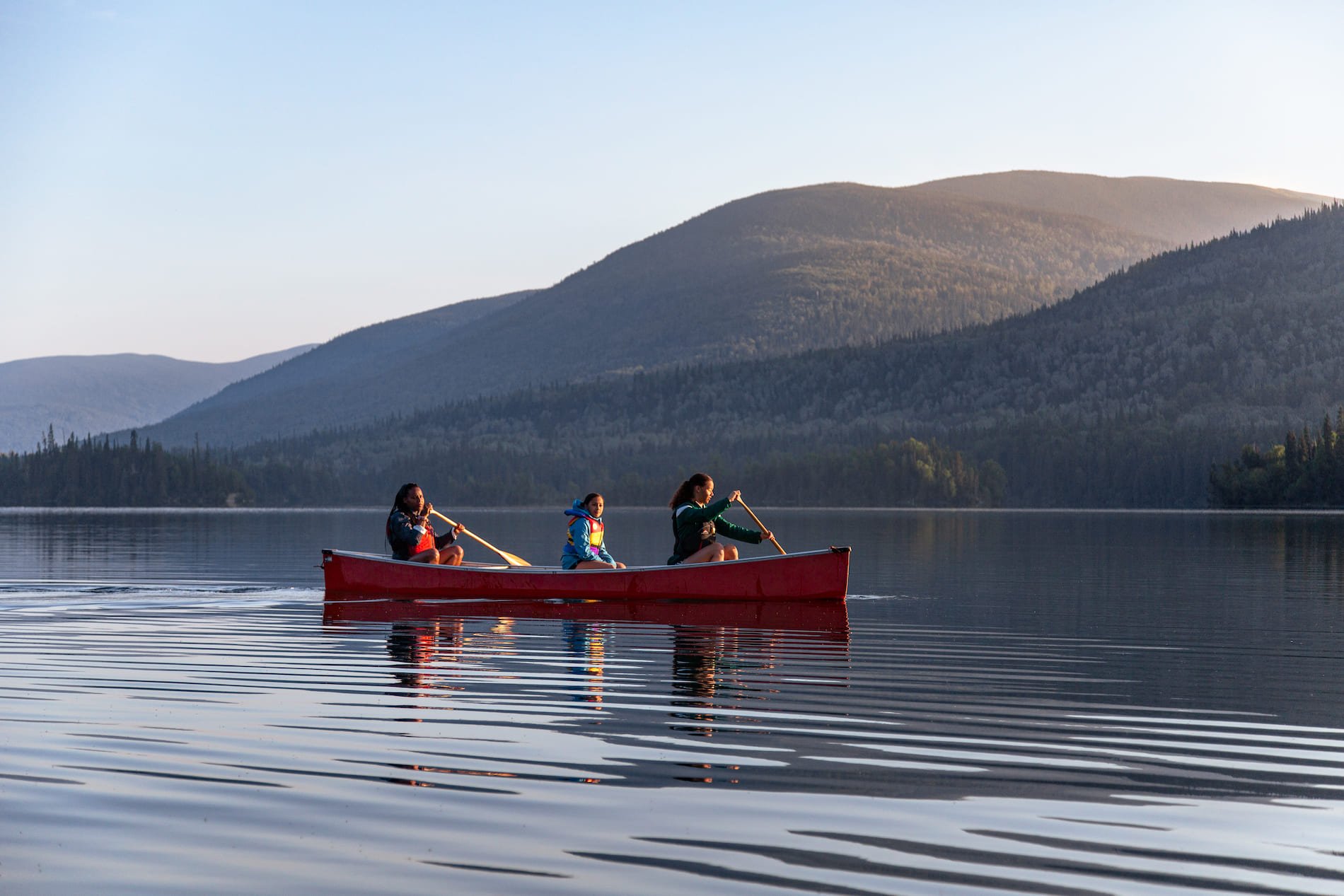 Family canoeing and kayaking on Morfee Lake in Mackenzie.