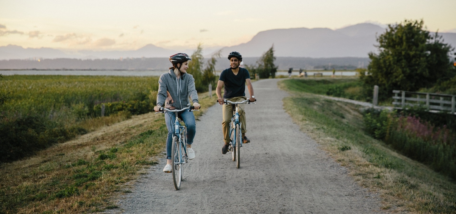 Two people cycling on a path in BC, Canada