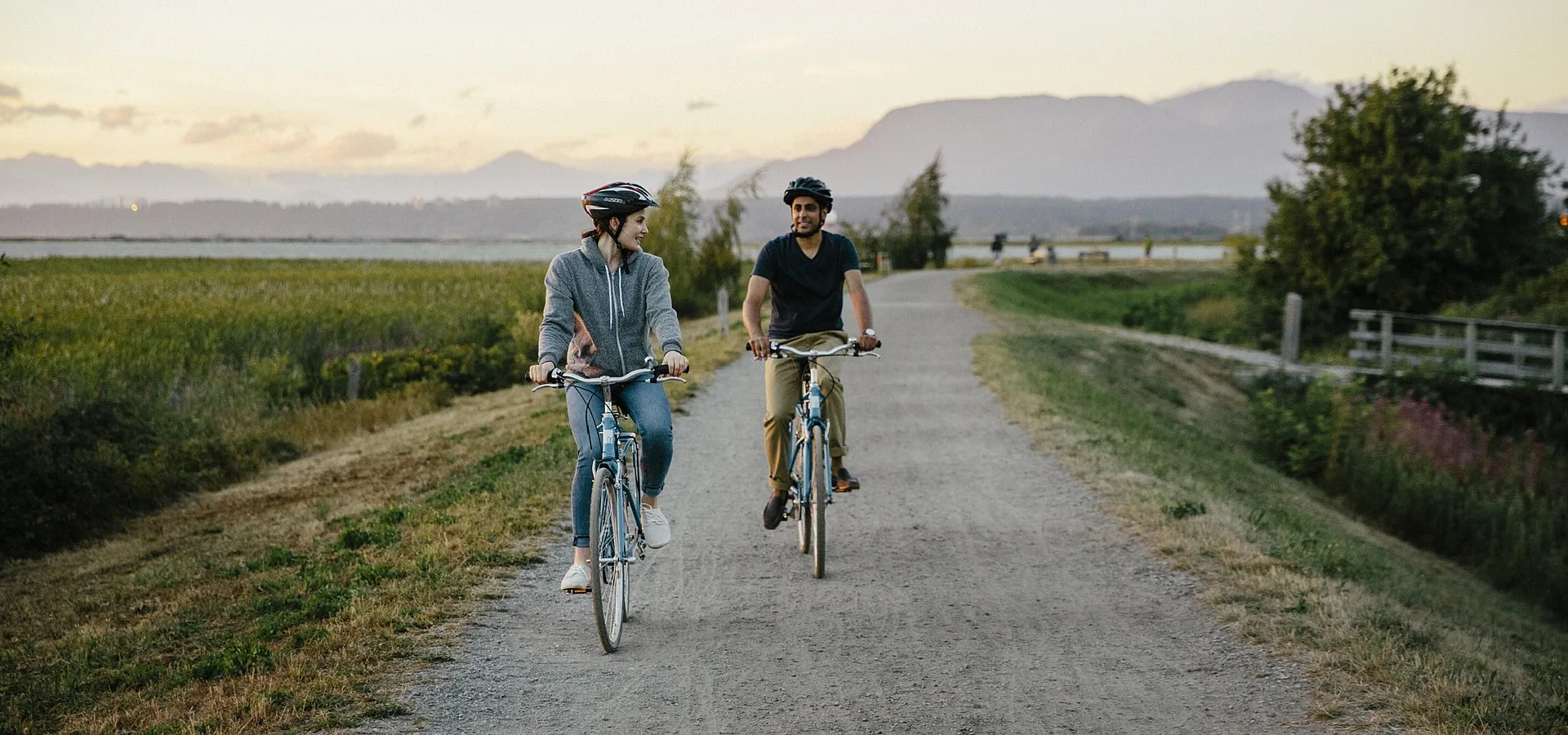 Two people cycling on a path in BC, Canada