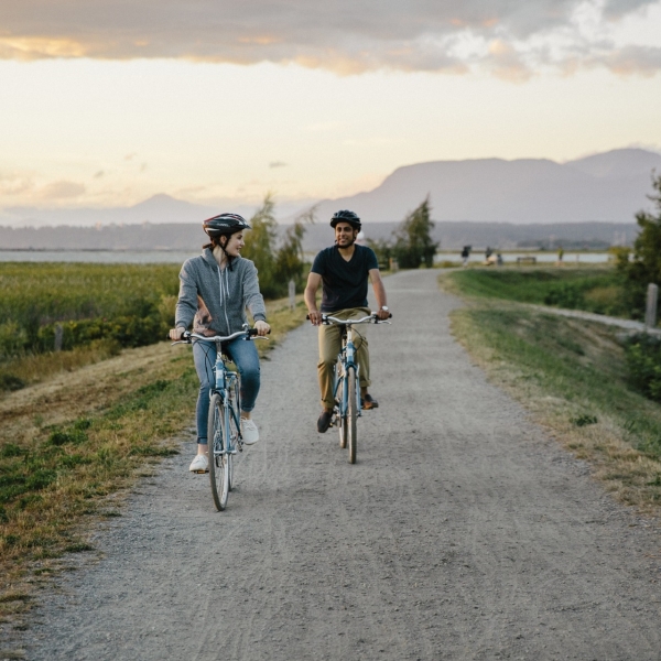 Two people cycling on a path in BC, Canada
