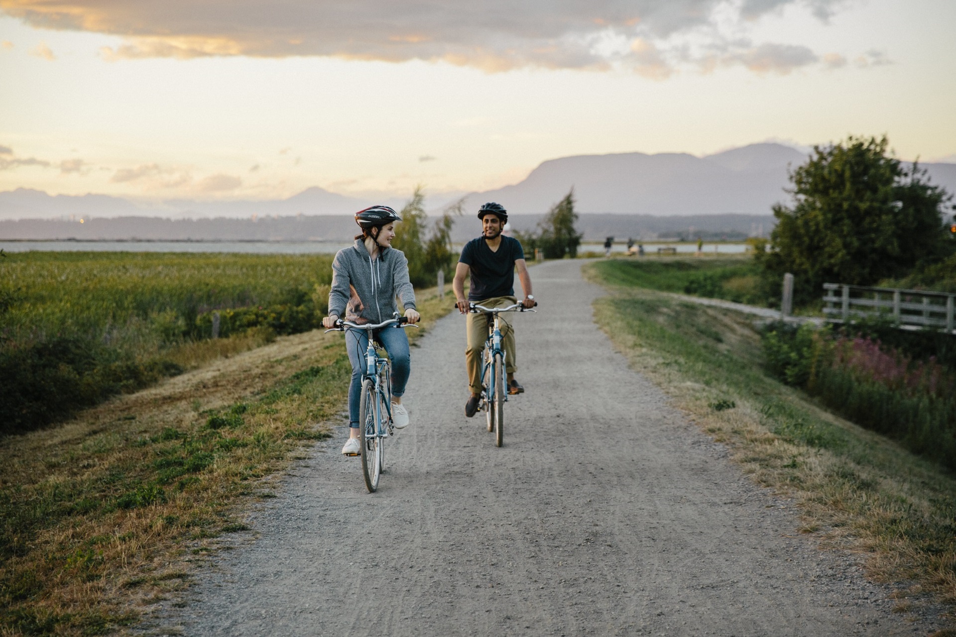 Two people cycling on a path in BC, Canada