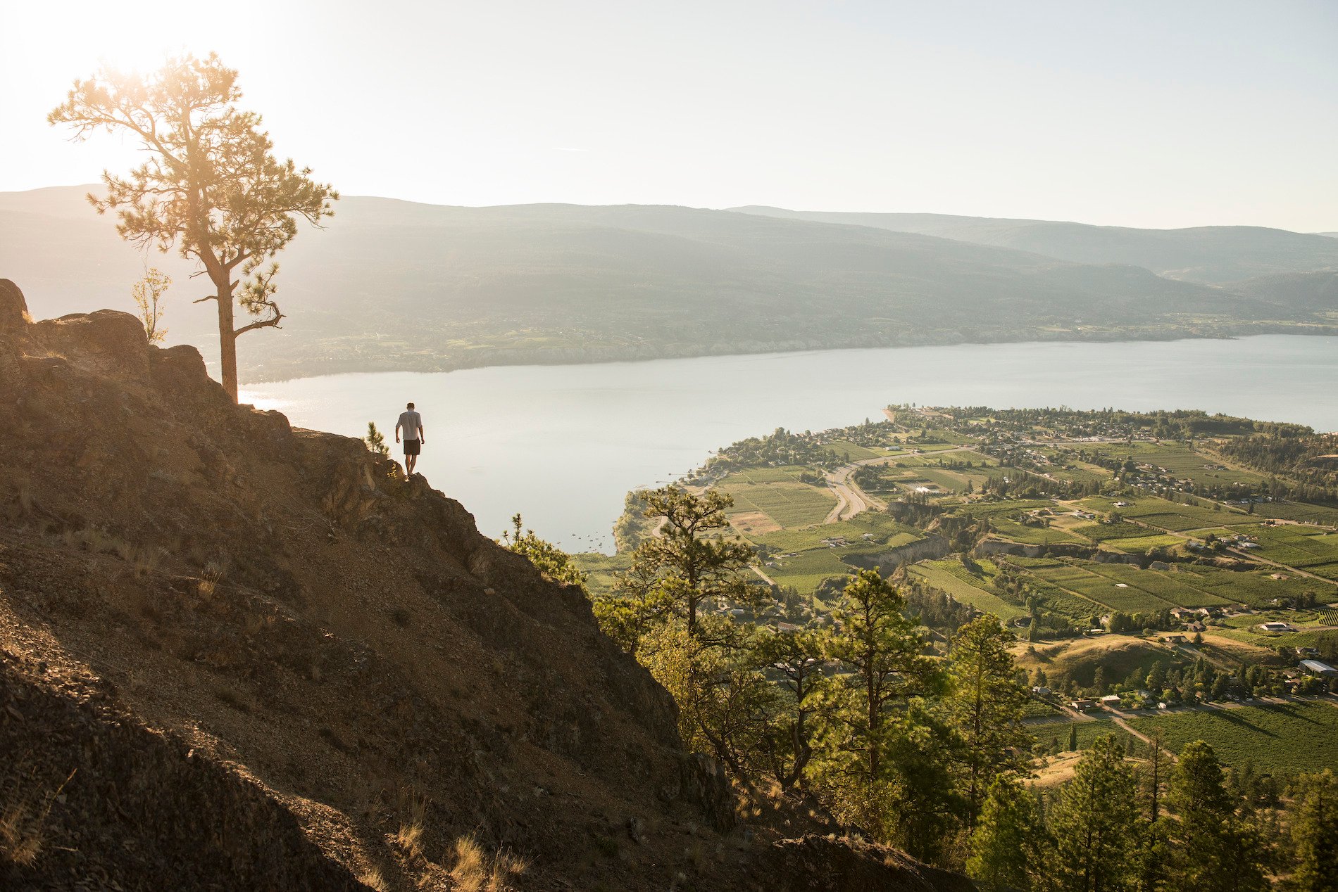 A hiker on Giant's Head Mountain with a view of Okanagan Lake