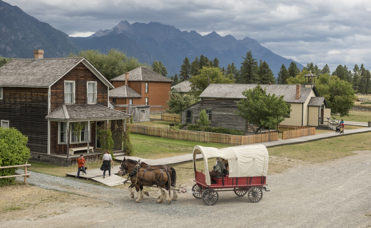 A horse drawn carriage in a village