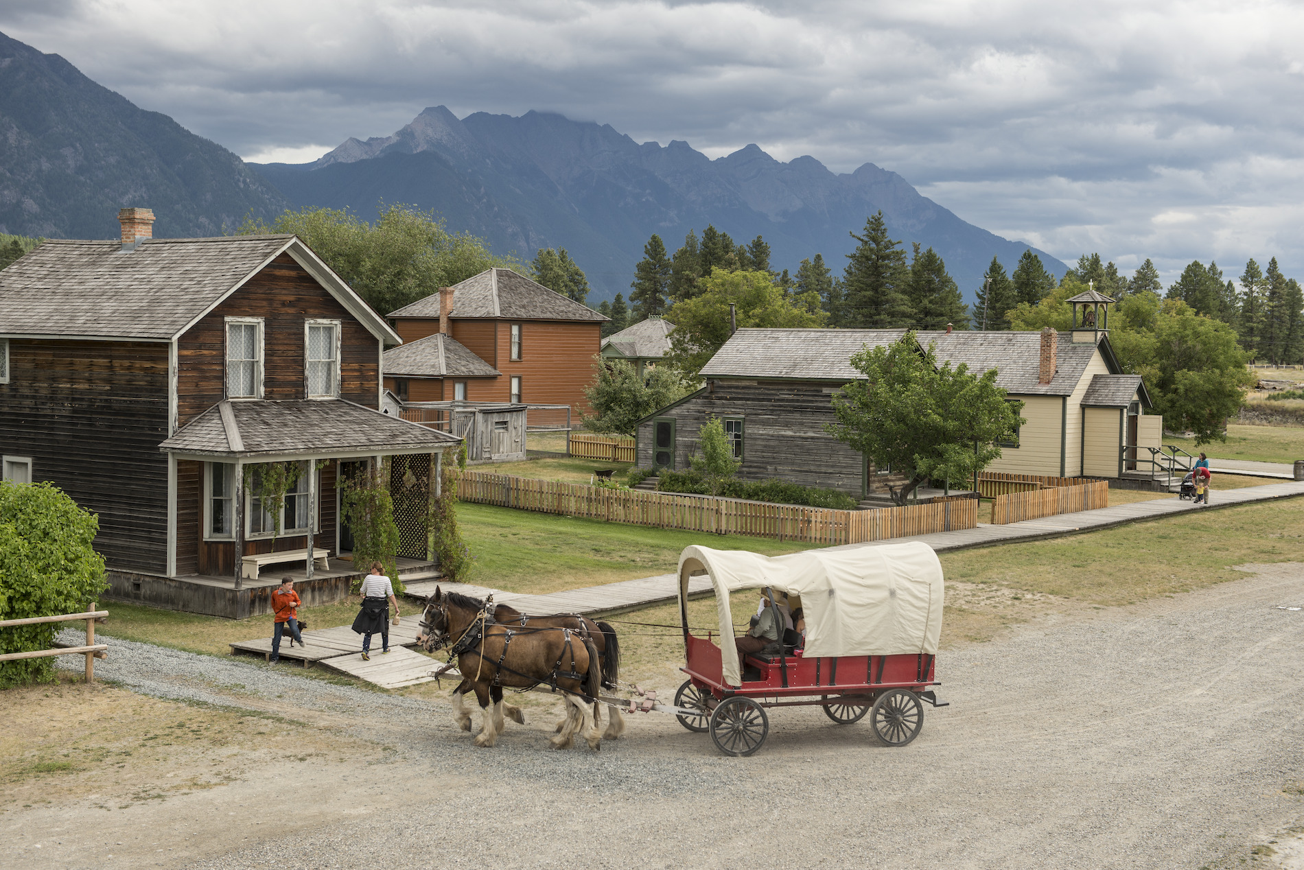 A horse drawn carriage in a village