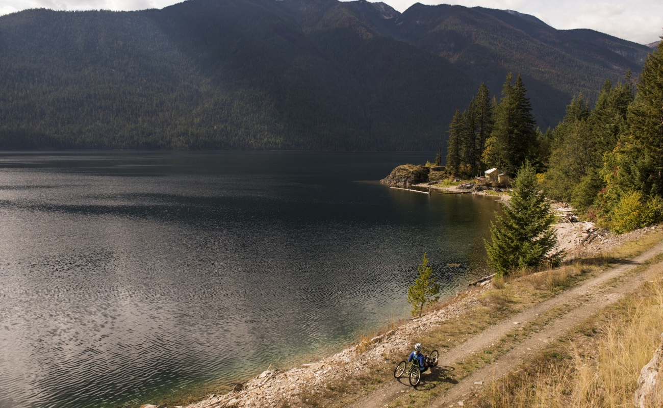 A person traveling down a trail by a lake