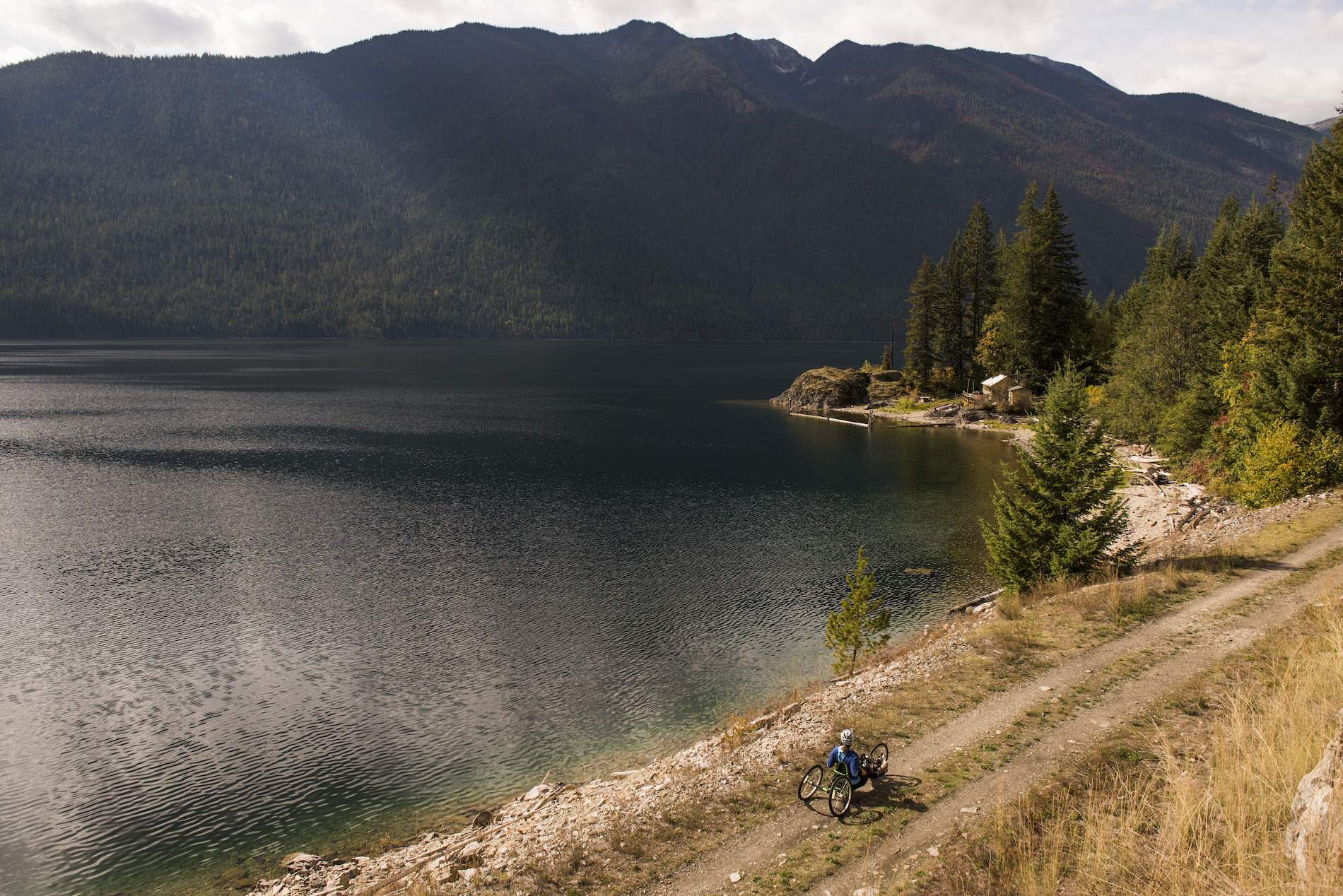 A person traveling down a trail by a lake