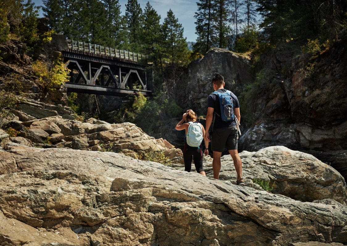 Two people hiking at Cascade Falls near Christina Lake