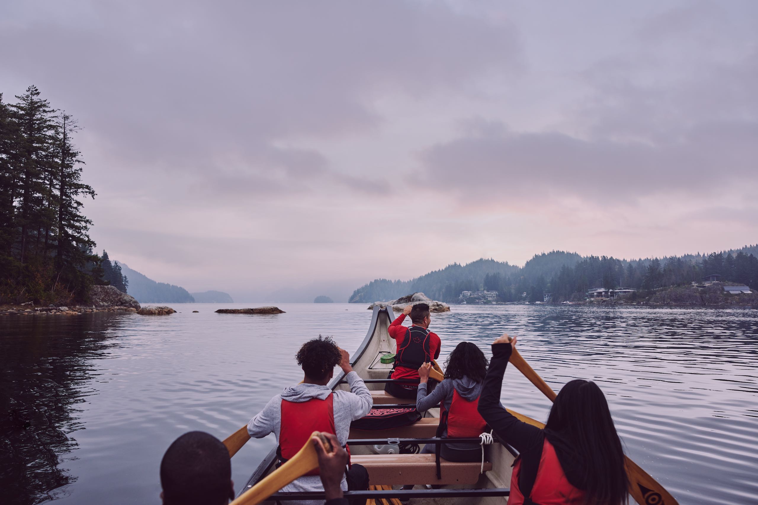 A group with Takaya Tours, rowing a traditional First Nations canoe in Deep Cove.