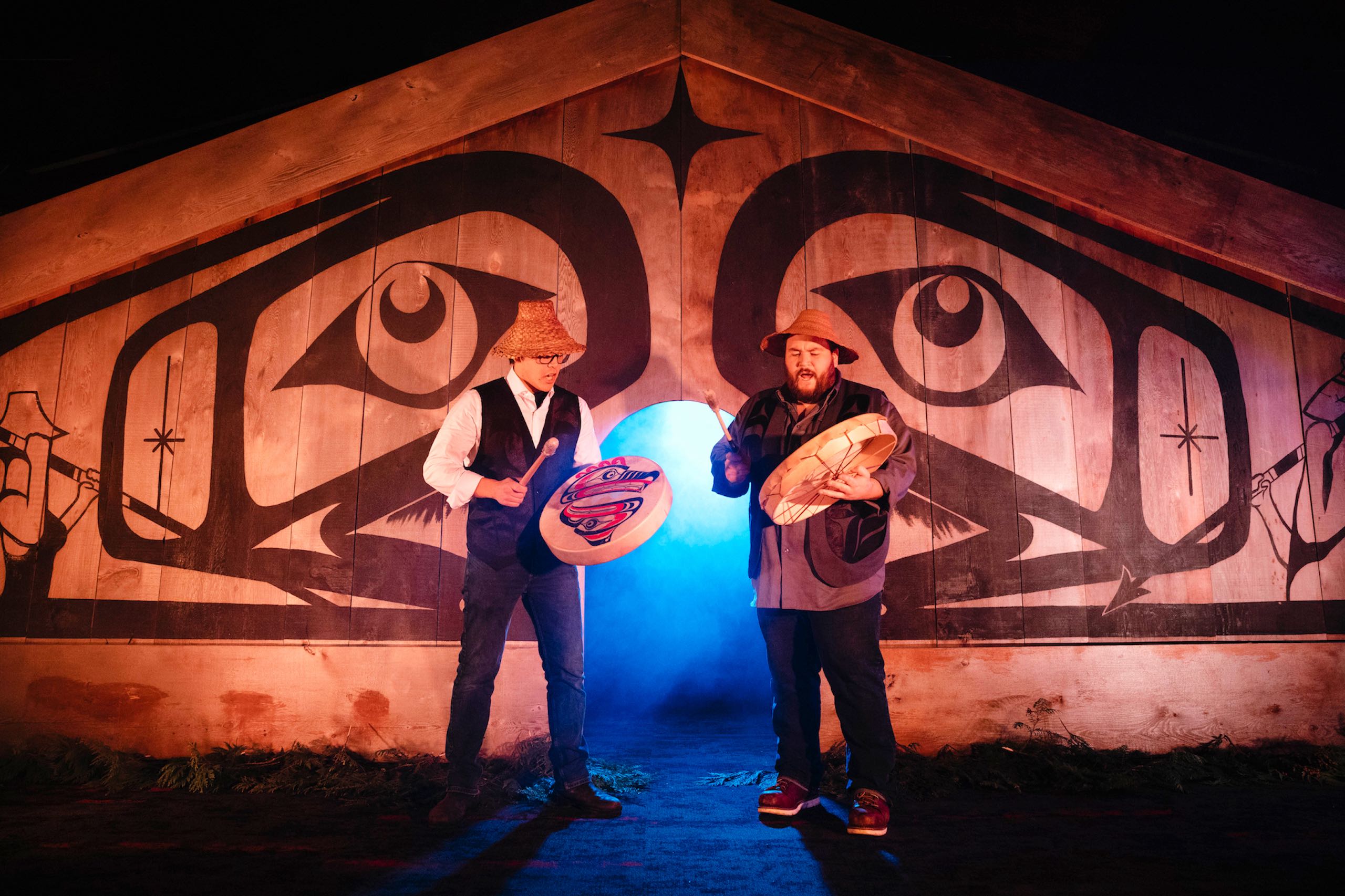 Two people drumming on stage