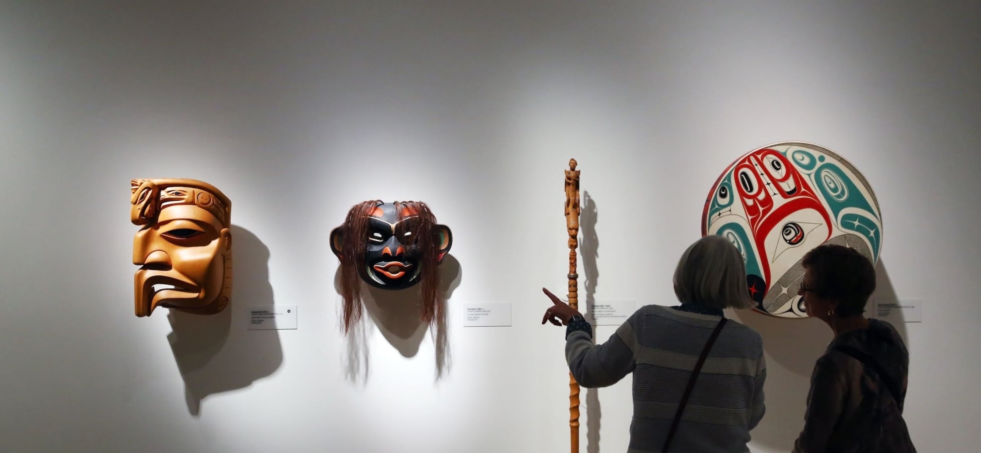 Visitors looking at the First Nations' art at the Audain Art Museum