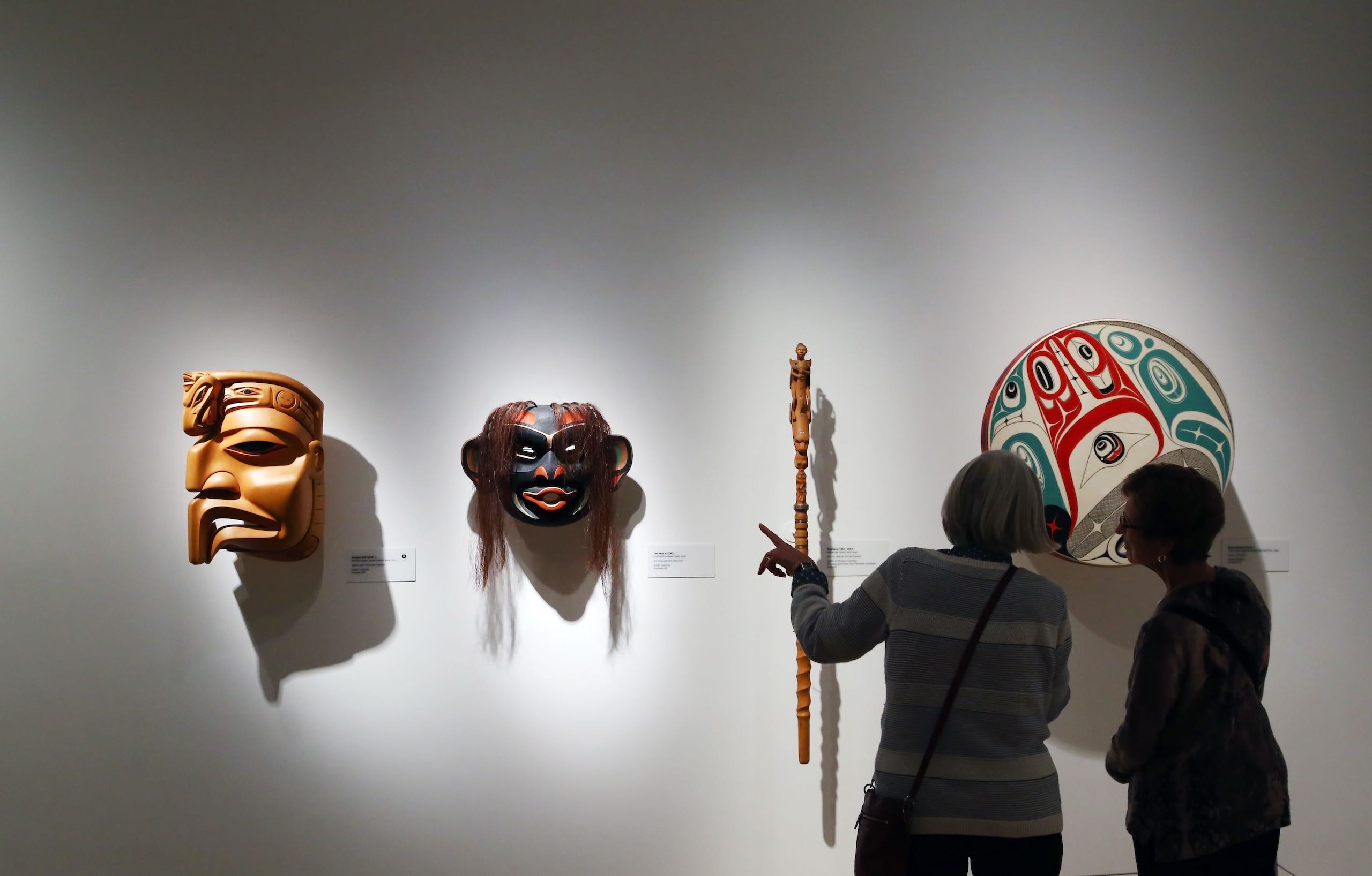 Visitors looking at the First Nations' art at the Audain Art Museum