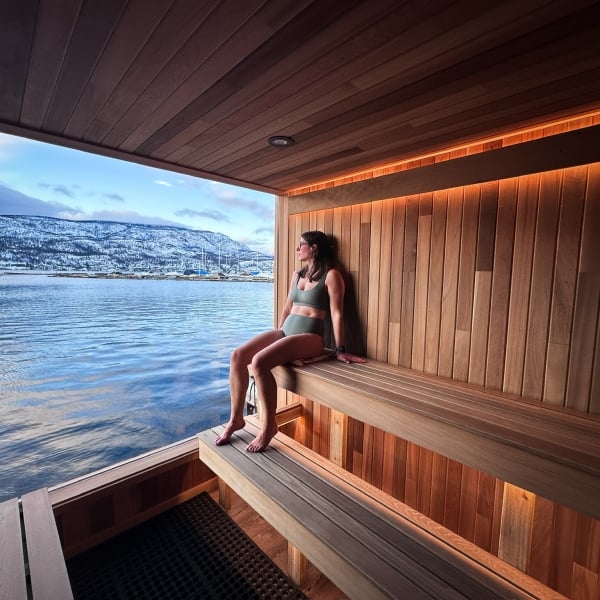 Guest relaxing in Löyly floating sauna in Kelowna, Löyly Floating Sauna
