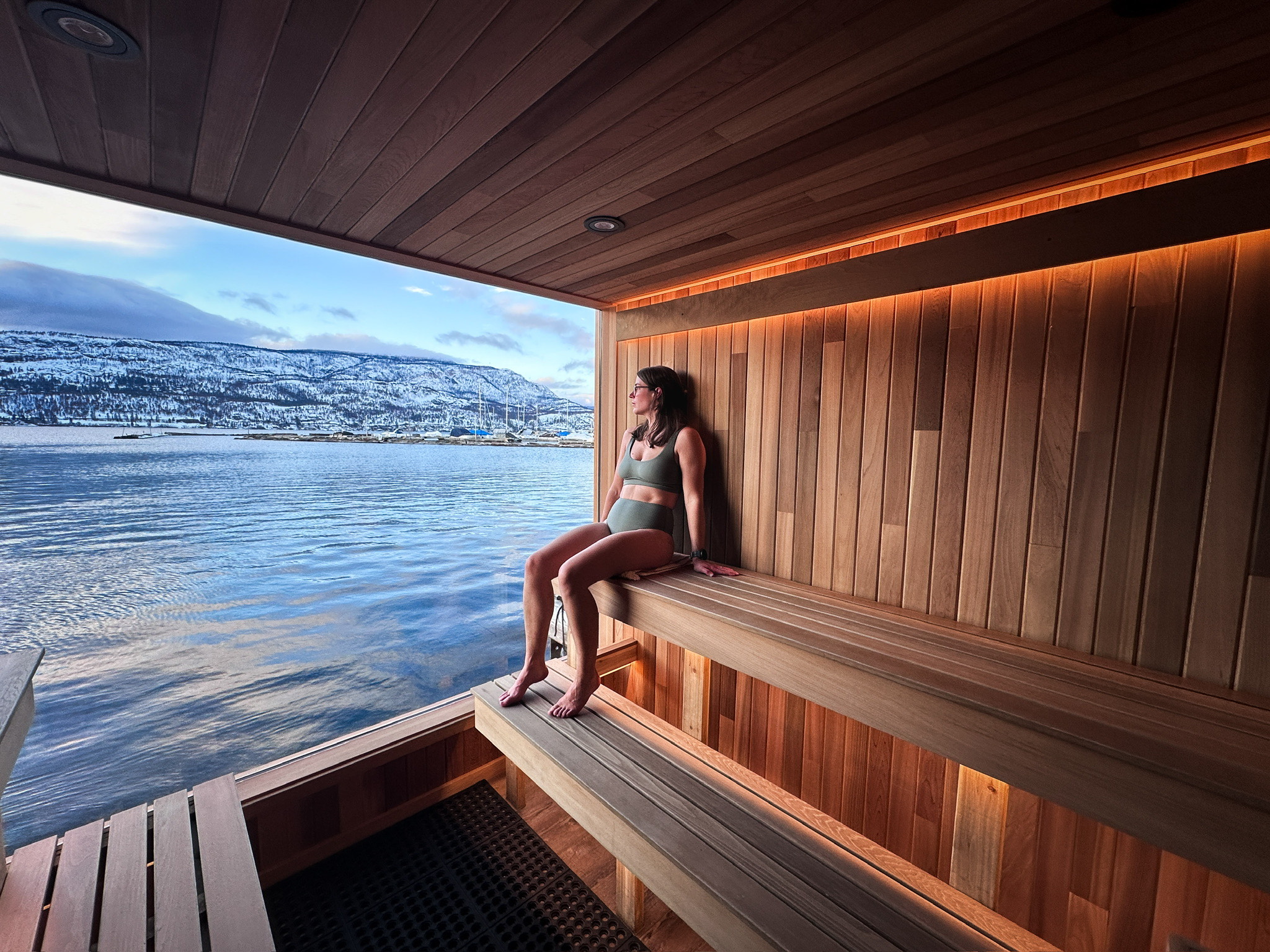 Guest relaxing in Löyly floating sauna in Kelowna, Löyly Floating Sauna