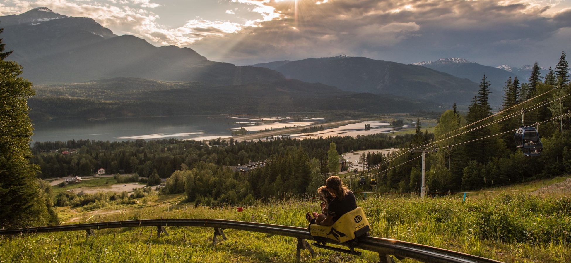 A mother and daughter enjoy The Pipe Mountain Coaster at Revelstoke Mountain Resort in Revelstoke, BC.