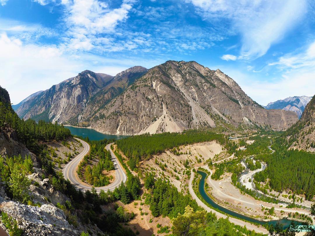 view of a winding highway by a mountain