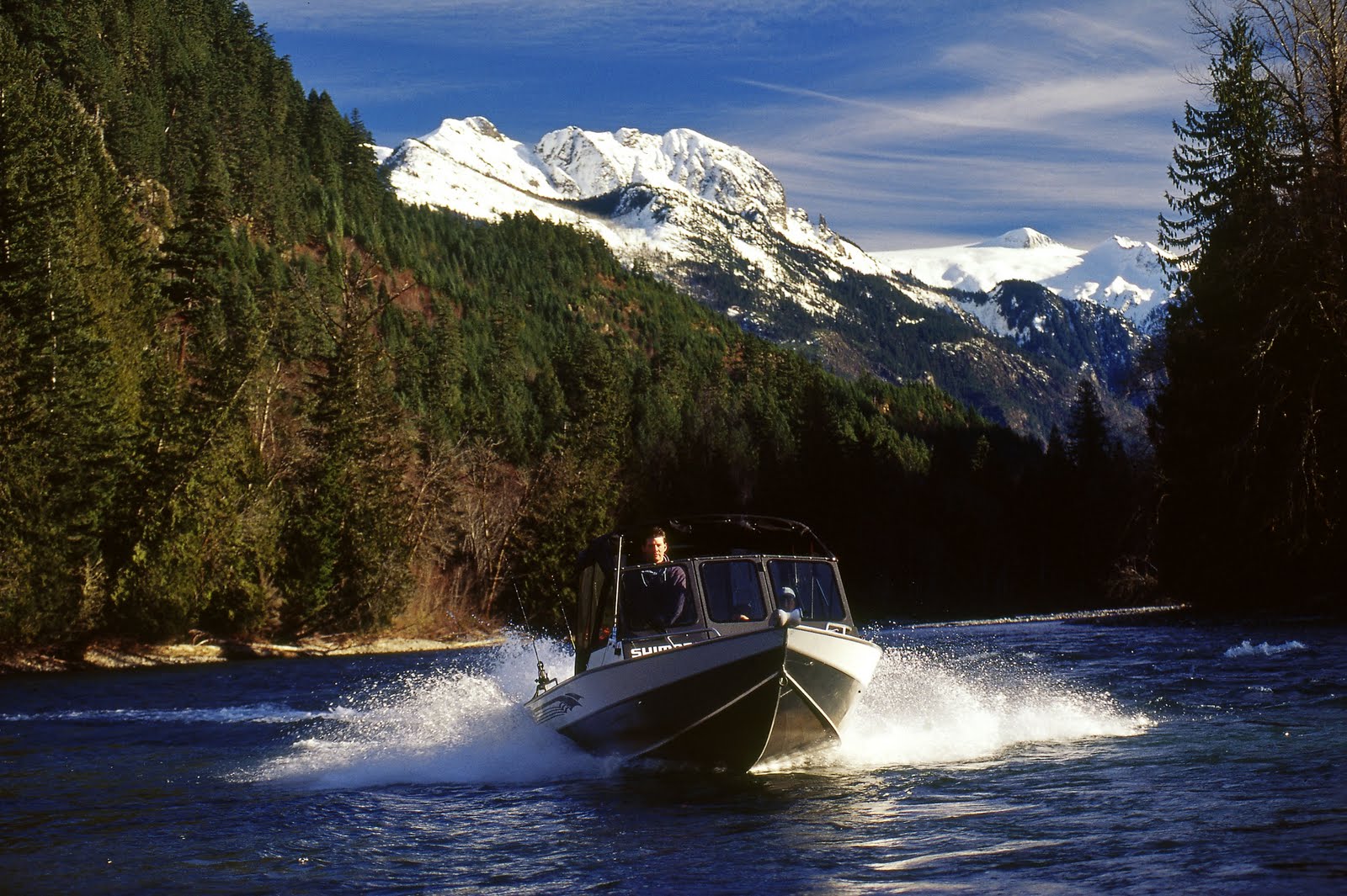 A boat speeds down the lake at Harrison Lake