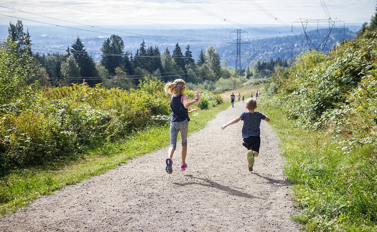 Two children run down the path on the Coquitlam Crunch