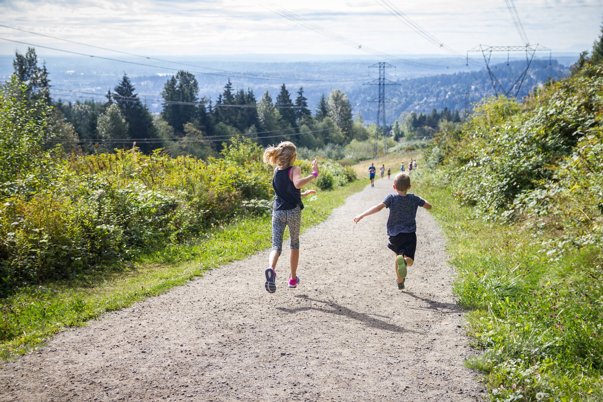 Two children run down the path on the Coquitlam Crunch