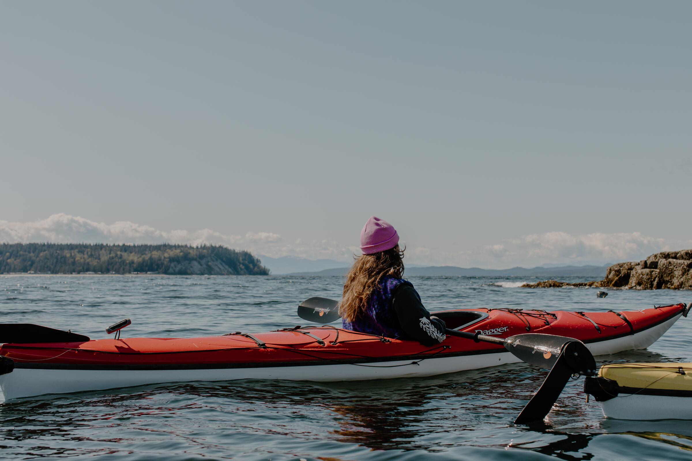 Kayakers paddle in the bay along the Sunshine Coast.